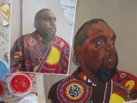 A printed reference photograph of Martumili artist Owen Biljabu next to a painted self-portrait
