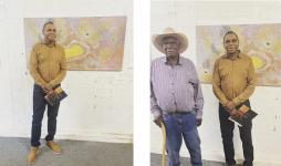 Martumili artists Muuki Taylor and Derrick Butt standing in front of Derrick Butt's Kulyakartu painting at Salon Des Refuses in Darwin